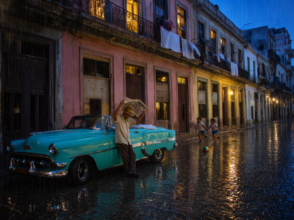 The street photograph relit as a rainy blue-hour evening with Krea 3 Edit