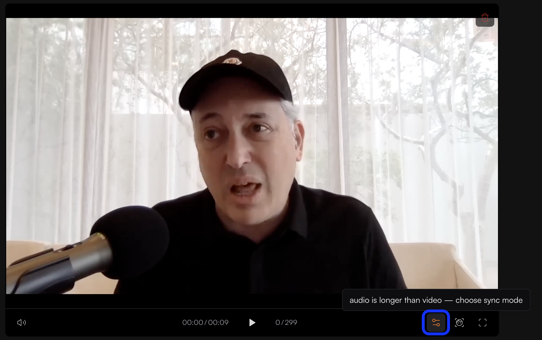 Image of a man speaking into a microphone during a video call or recording, with an on-screen tip about audio being longer than video and sync mode options